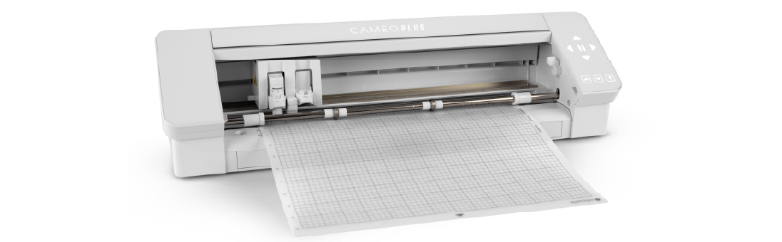 Image of a Cameo Plus cutting machine with a cutting mat loaded, featuring a grid pattern.